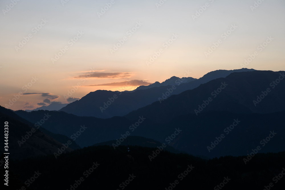 Mountains are lit by the setting sun in the Tusheti region.