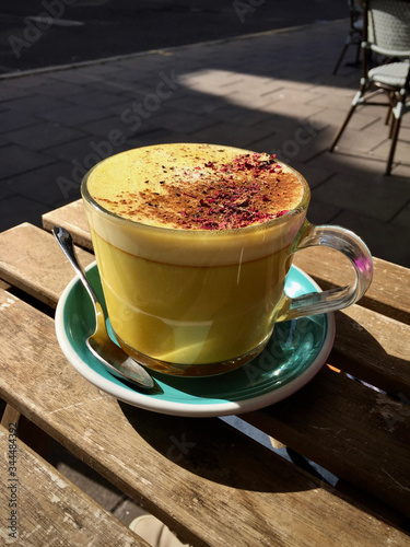Turmeric Latte on a table outside a street cafe