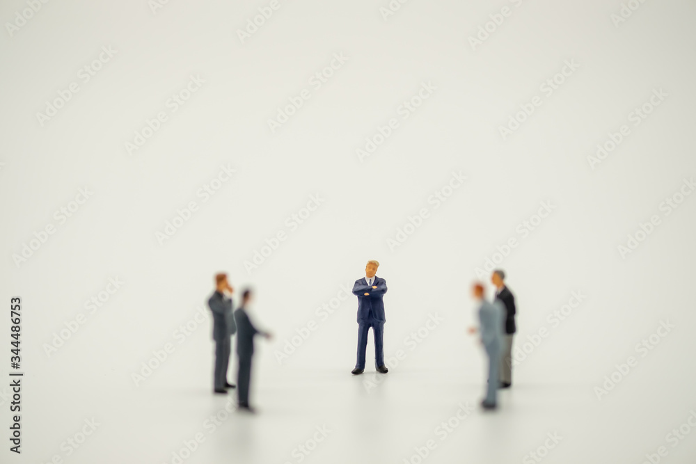 Businessman miniature people figure standing discuss with teamwork on white background with copy space.