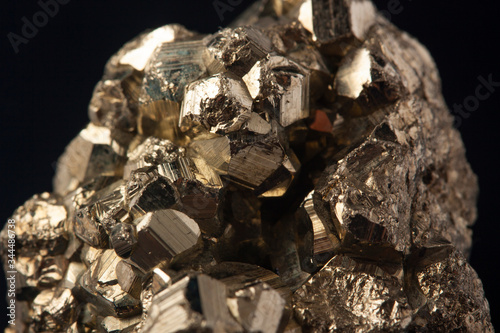 Pyrites crystals on the black background, macro, FeS2