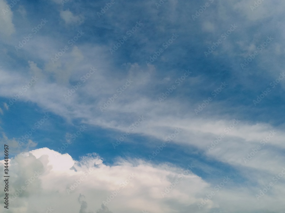 black and white clouds with blue sky