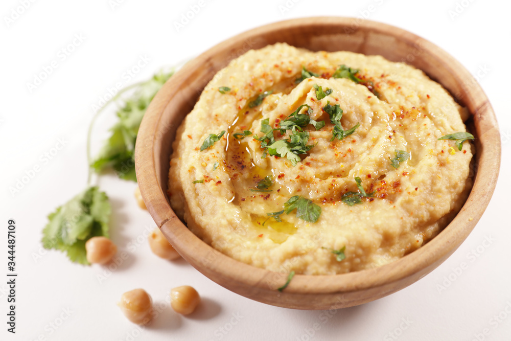 bowl of hummus on wood background bowl of hummus on wood background