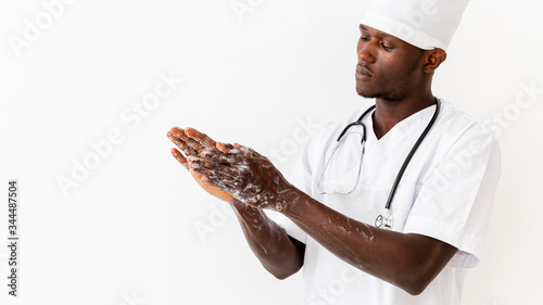 Specialist black male doctor washing his hands