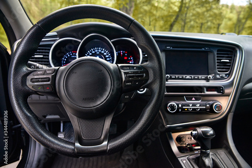 car dashboard and steering wheel, modern car interior design © izikmd