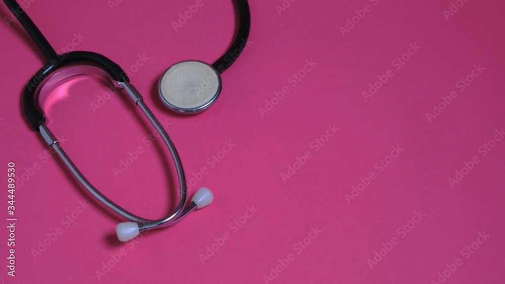On a pink background statoscope. The concept of medicine. On a pink background statoscope. The concept of medicine.