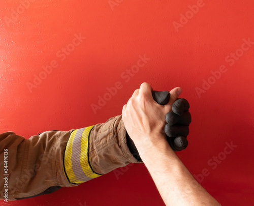 Firefighter shakes hands with a man to help