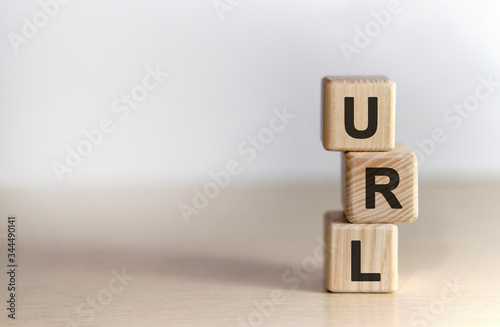 URL - concept on vertical wooden cubes on a white background