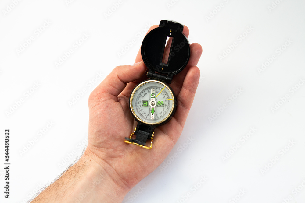 compass in hand on a white background compass in hand on a white background