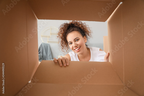 Happy woman with open box, view from inside © Pixel-Shot
