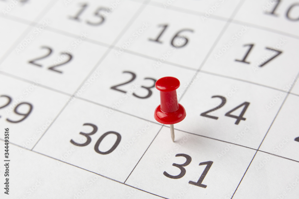 end of month marked on the calendar with a red pushpin end of month marked on the calendar with a red pushpin