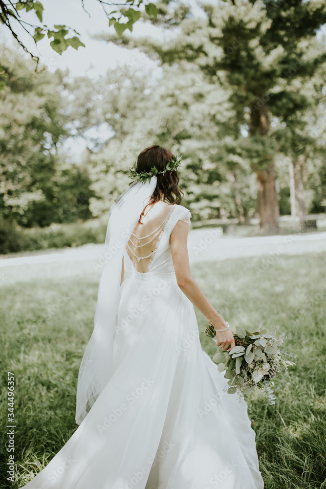 brides and her friend stay in back and show wedding bouquet brides bouquet in the garden flowers dress beuty bride stay in the forest hairstyle haircut