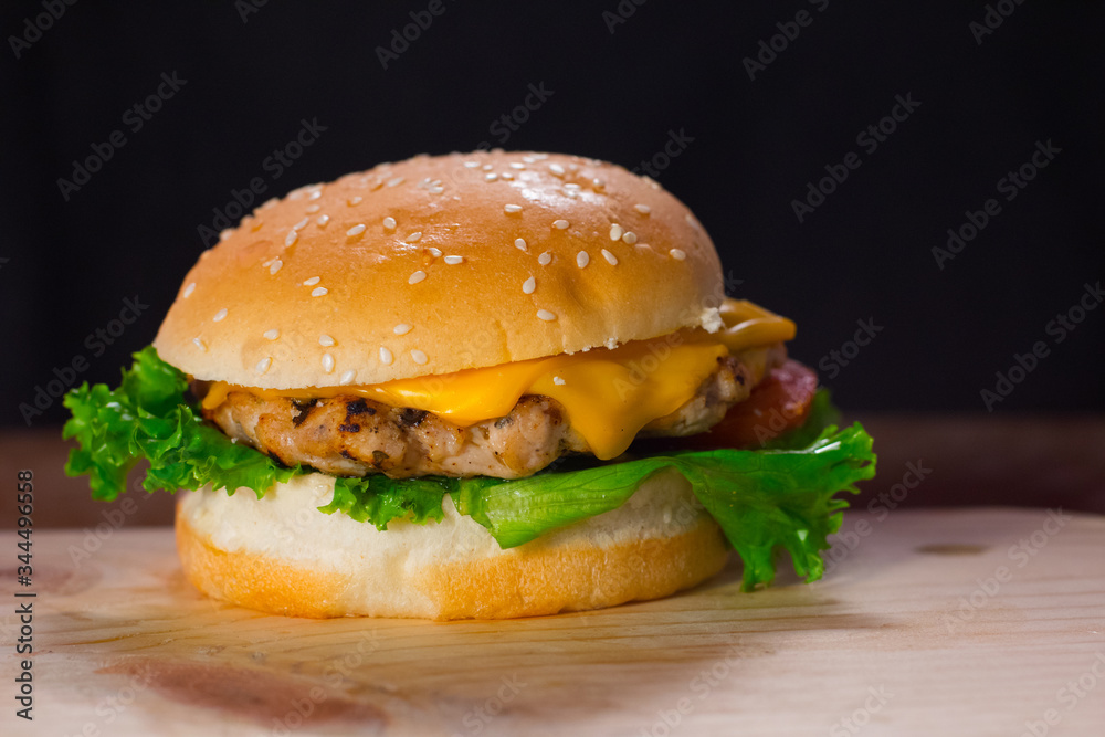 Fresh Delicious Burger with Lettuce and Cheese Served Closeup on Wooden Table