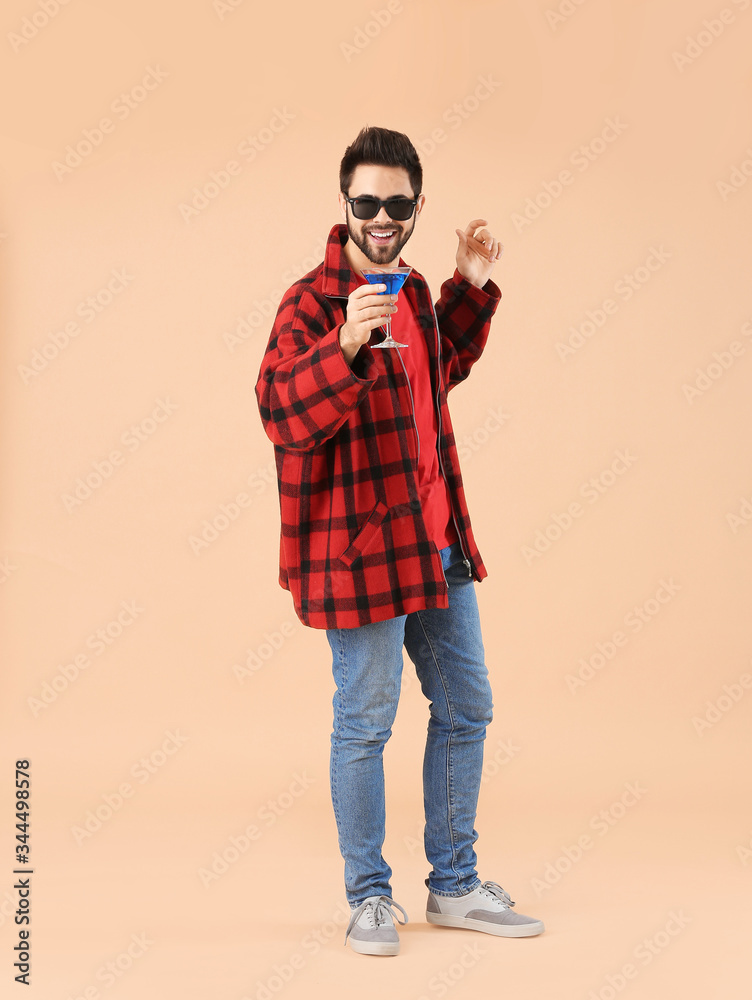 Happy young man with cocktail on color background Happy young man with cocktail on color background