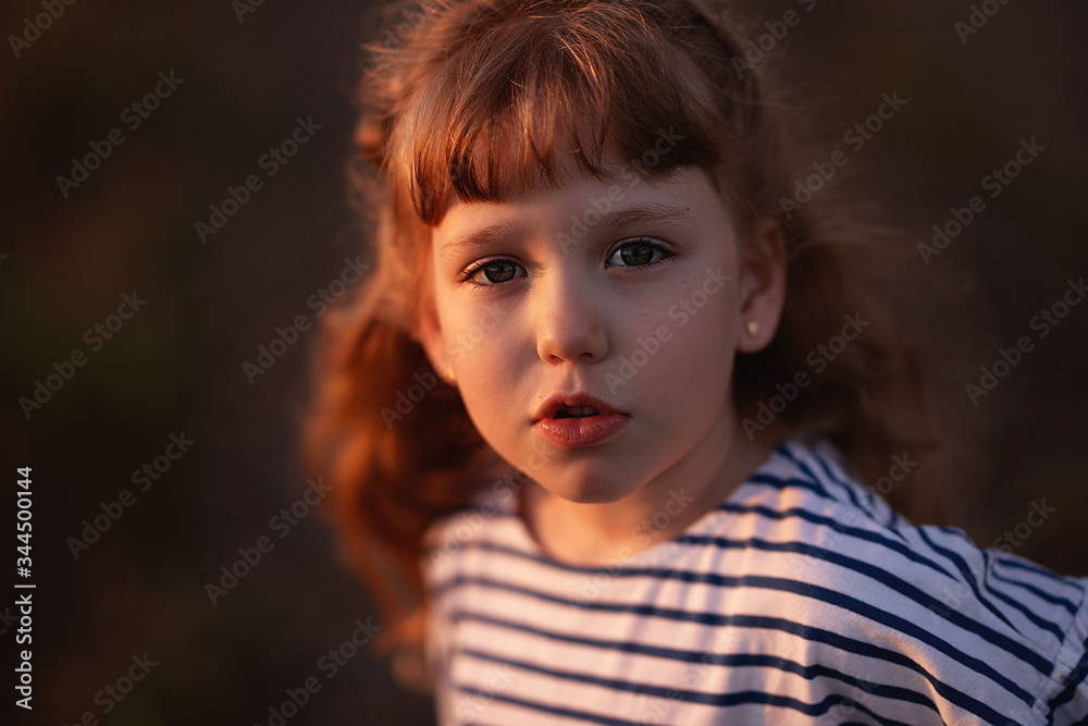 Displeased girl with luminous hair in the summer sunset
Displeased girl with luminous hair in the summer sunset