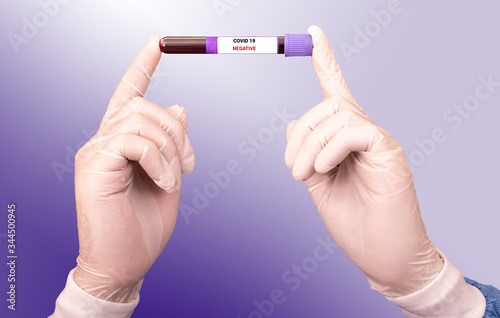 Laboratory technician hold on blood sample tube tested negative for Covid 19. Testing for presence of coronavirus photo