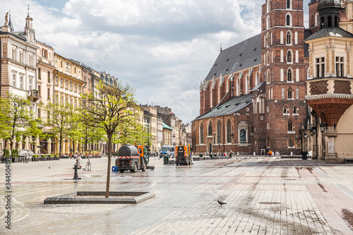 Almost empty Krakow Market Square in the time of pandemia (Coronavirus - Covid-19). Machines disinfect the surface