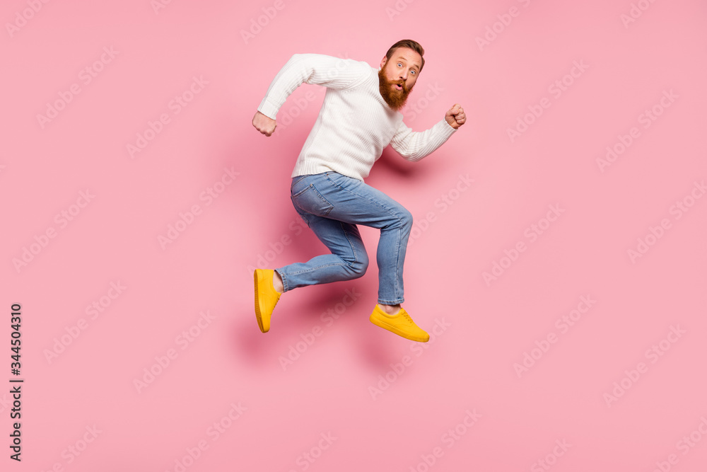 Full size profile side photo of astonished guy jump impressed by wonderful unbelievable discounts run fast wear sweater shoes isolated over pastel color background