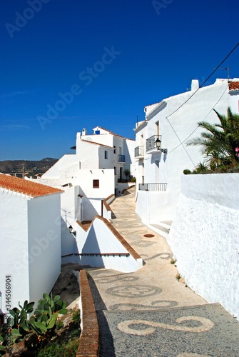 View along a whitewashed village street, Frigiliana, Andalusia, Spain.