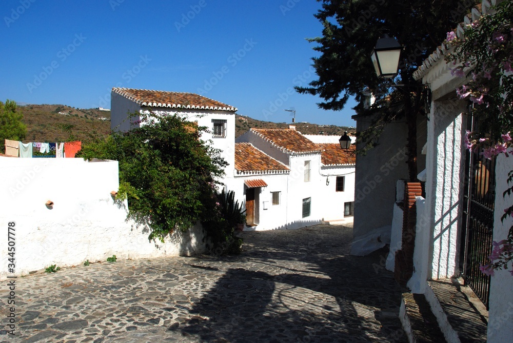 Townhouses along a village street, Macharaviaya, Andalusia, Spain.