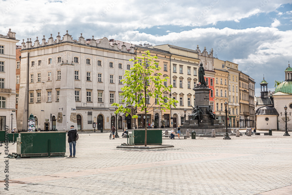 Almost empty market square in krakow during pandemic (coronavirus, covid-19) time. A sunny warm day in Krakow, Lesser Poland, Poland.