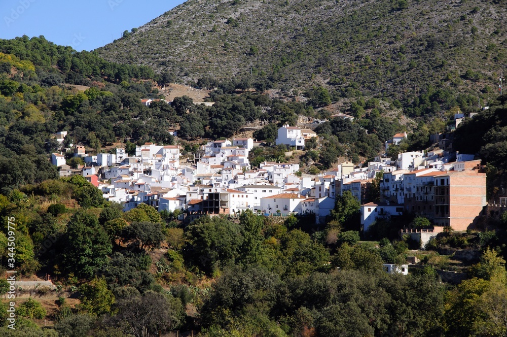 View of whitewashed village and surrounding countryside, Igualeja, Andalusia, Spain.