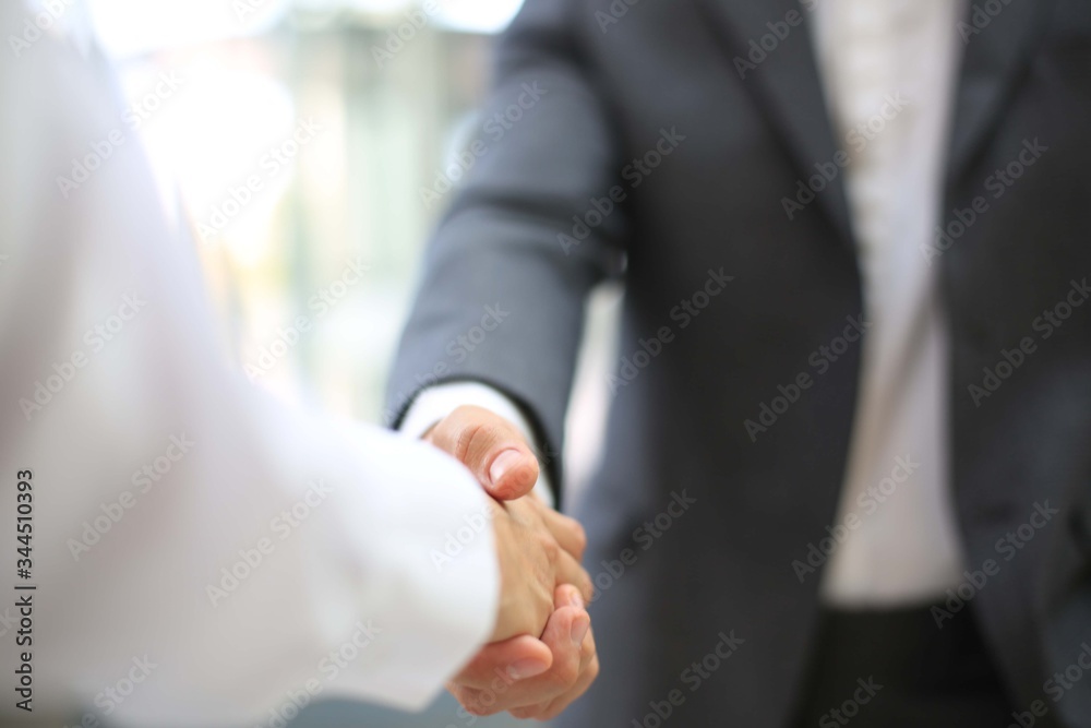 Business partnership handshake concept.Photo two coworkers handshaking process.Successful deal after a great meeting.