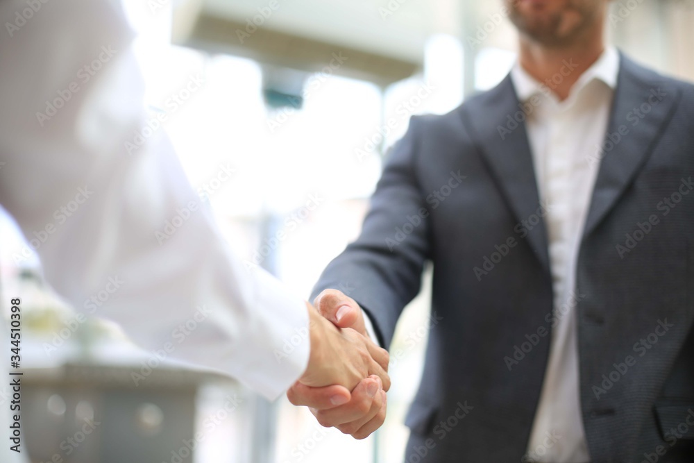 Business partnership handshake concept.Photo two coworkers handshaking process.Successful deal after a great meeting. Business partnership handshake concept.Photo two coworkers handshaking process.Successful deal after a great meeting.