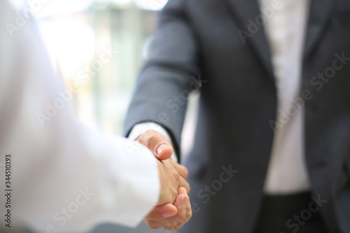 Business partnership handshake concept.Photo two coworkers handshaking process.Successful deal after a great meeting. © Tony Alexson