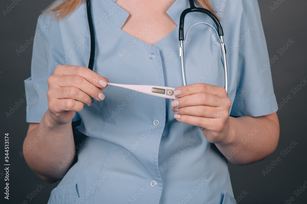 The doctor measures the temperature with a thermometer. Doctor with a thermometer in his hands. Thermometer close-up. Healthy lifestyle, doctor, viral concept
The doctor measures the temperature with a thermometer. Doctor with a thermometer in his hands. Thermometer close-up. Healthy lifestyle, doctor, viral concept