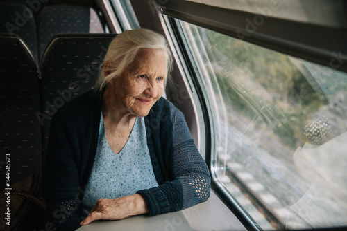 Elderly woman looking in window