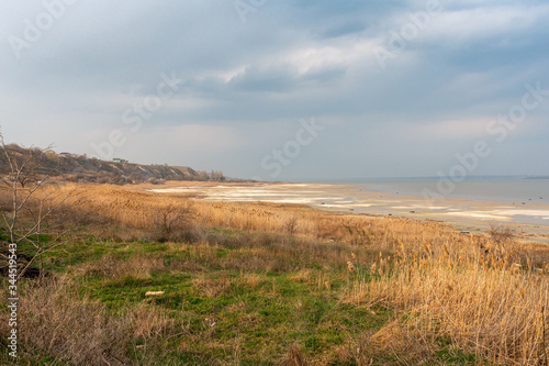 Rural Landscape on a Waterside of Estuary in Cloudy Moody Spring Day