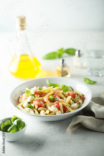 Pasta salad with tomato, mozzarella and basil