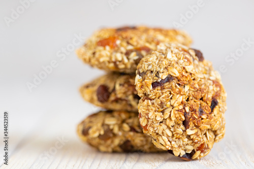 Homemade tasty oatmeal cookies with rasins, dried apricots and date fruits. Healthy snack concept. Sweet dessert. Close up photo