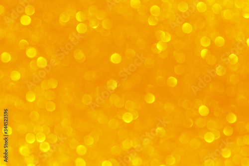 Yellow gold orange light glitter bokeh background. Concept for New Year, Christmas and All Celebrations.