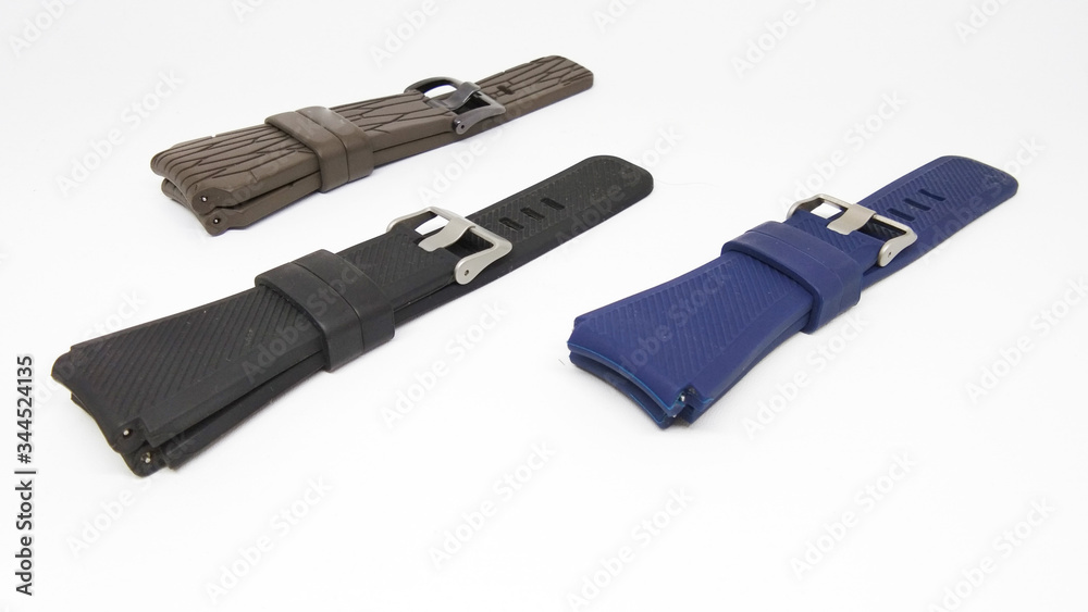 Closeup three straps watch isolated on white background. Navy rubber watch band, Brown rubber watch band, Black rubber watch band Closeup three straps watch isolated on white background. Navy rubber watch band, Brown rubber watch band, Black rubber watch band