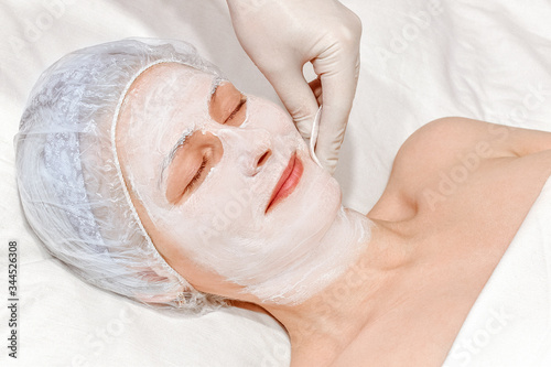 girl does a rejuvenating procedure of the skin on the face close-up. cosmetic procedure on the face.