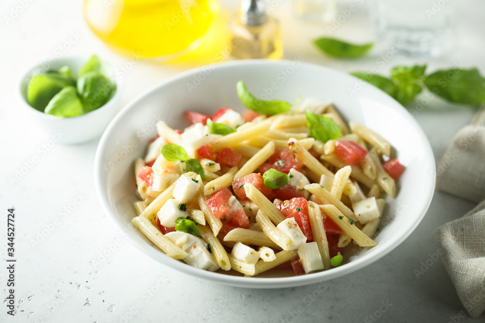 Pasta salad with tomato, mozzarella and basil Pasta salad with tomato, mozzarella and basil