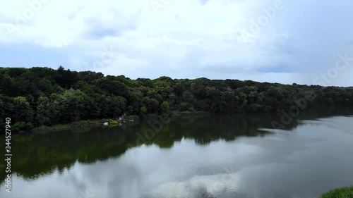 Aerial footage of town with river and forest. Taken with drone camera.