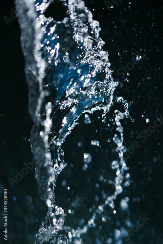 blue water splash with drops on black background
