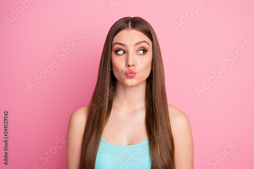Close-up portrait of her she nice attractive lovely lovable winsome curious cheerful cheery straight-haired girl sending air kiss looking aside isolated over pink pastel color background