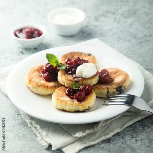 Homemade cottage cheese cakes with cherry sauce