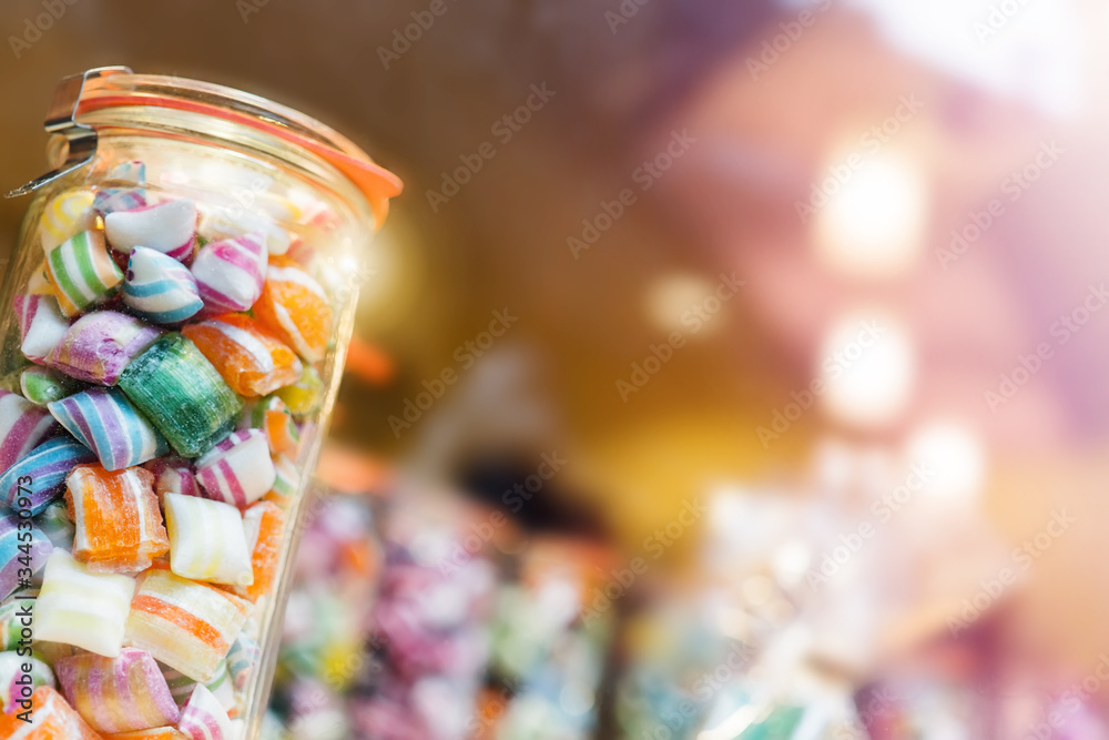 Blur background of delicious sweet beautiful fantasy colourful jar box of candy treat for summer holiday kids gift souvenir. Eat too much bonbon lollipop sugar is toxic unhealthy nutrition addiction