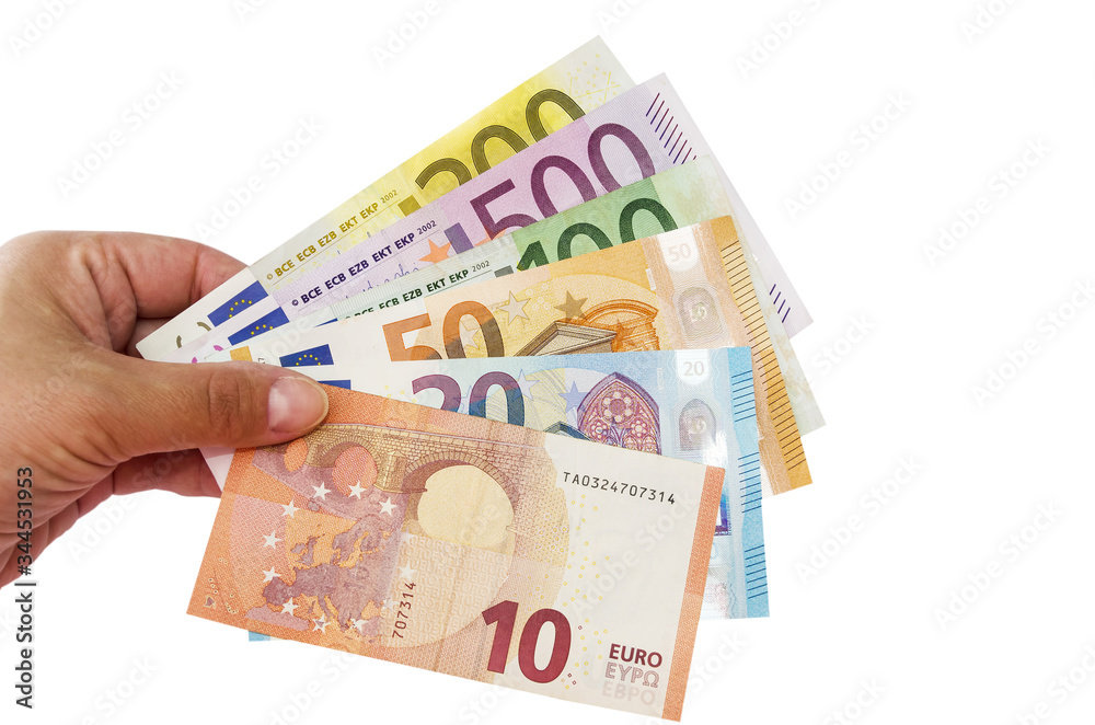 different euros in hand isolated on a white background. different euros in hand isolated on a white background.