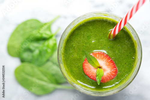 Wallpaper Mural Overhead View of a Fresh Green Spinach Smoothie with Strawberry and mint Garnish Torontodigital.ca