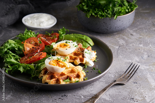 Healthy organic breakfast. Waffles, herbs, tomatoes,salad,eggs, spices served in a plate