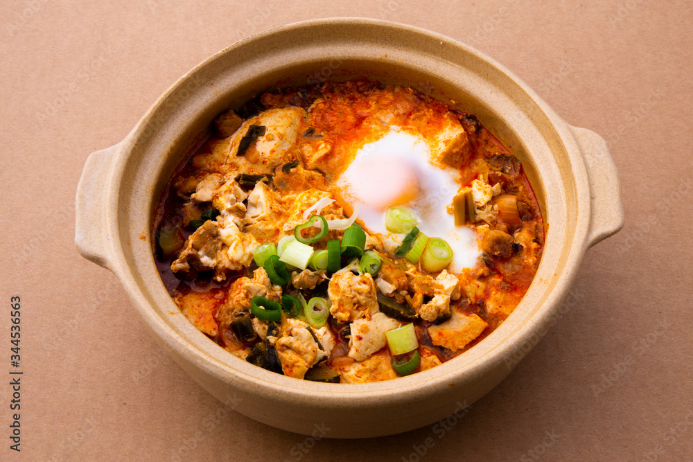 Korean spicy silken tofu stew which is called Sundubu Jjigae Korean spicy silken tofu stew which is called Sundubu Jjigae