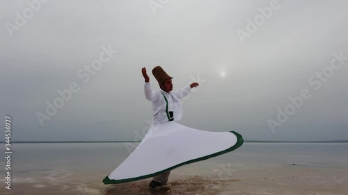 sunset and whirling at the sea, sufi. sufi whirling (Turkish: Semazen) is a form of Sama or physically active meditation which originated among Sufis. 4k photo