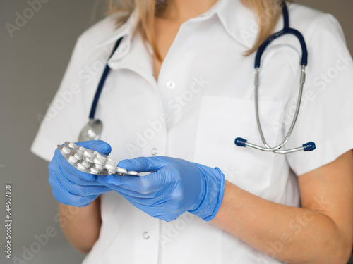 Close-up doctor wearing medical gloves