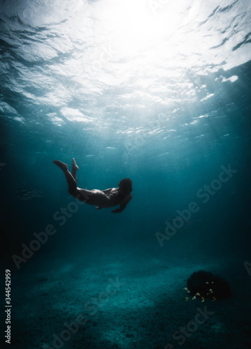 Girl diving in the middle of the Caribbean Sea © alessiosaveri