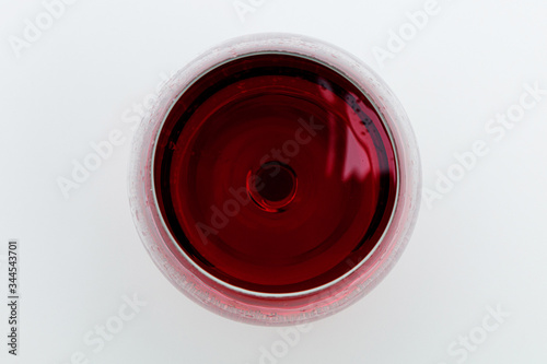 Glass of red wine on a white background. View from above